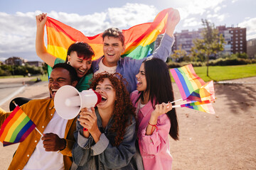 Young activists shouting with megaphone at lgbtq pride parade