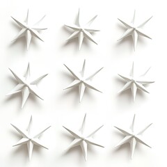 Fototapeta premium Nine White Star Shaped Objects Arranged in a Grid Pattern on White Background