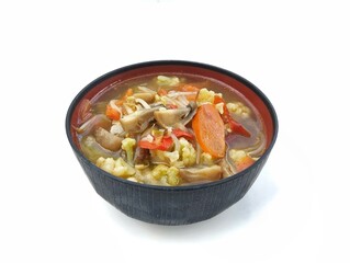 Mushroom and vegetables soup in bowl isolated on white background 