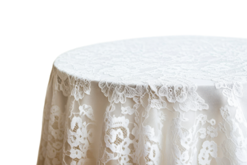 Round table with white lace tablecloth against black backdrop, cut out transparent