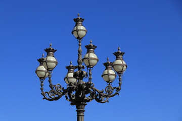 Vintage Lamp Post Detail Against a Blue Sky at St. Peter's Square in Rome, Italy