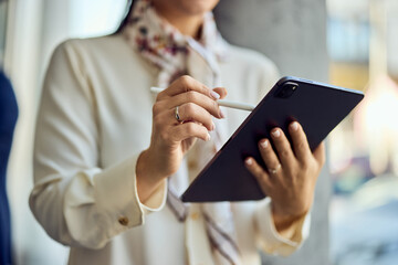 Professional Woman Using Digital Tablet with Stylus for Work
