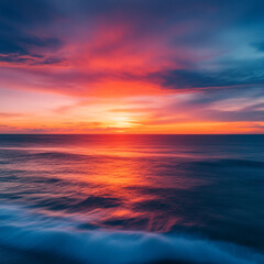 Obraz premium A vibrant sunset over the ocean with colorful clouds and reflections on the water surface creating waves