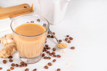 Fresh brewed ginger coffee latte cup. Creamy hot drink with ginger powder and ginger root, on white background. Healthy hot beverage. alternative medicine, remedy 