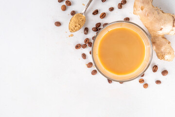 Fresh brewed ginger coffee latte cup. Creamy hot drink with ginger powder and ginger root, on white background. Healthy hot beverage. alternative medicine, remedy 
