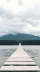 Lake pier for mountain view, cloudy day.