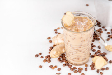 Cold brewed ginger coffee latte cup. Creamy iced drink with ginger powder and ginger root, on white background. Healthy hot beverage. alternative medicine, remedy 