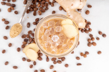 Cold brewed ginger coffee latte cup. Creamy iced drink with ginger powder and ginger root, on white background. Healthy hot beverage. alternative medicine, remedy 