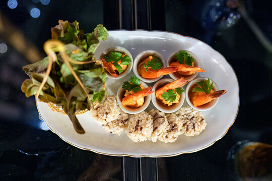 Gourmet seafood spicy shrimp, crispy rice, vegetable serving on table