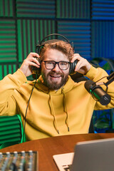 Handsome man radio DJ hosting a radio show, entertainment and communication concept