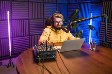 Handsome man radio DJ hosting a radio show, entertainment and communication concept