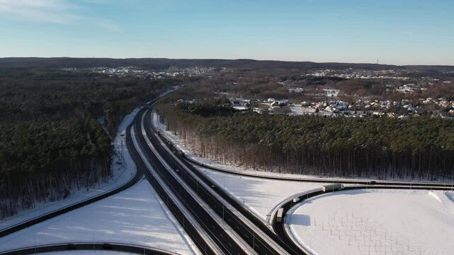 Aerial view of a road junction in a winter landscape. Motorway road junction.