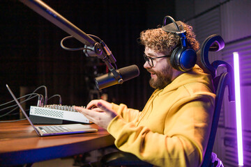 Live streaming with smiling millennial man as radio presenter with microphone, talk show or...