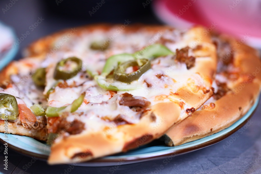 Poster a close-up view of a delicious-looking pizza on a plate, ready for serving.