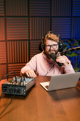 Handsome man radio DJ hosting a radio show, entertainment and communication concept