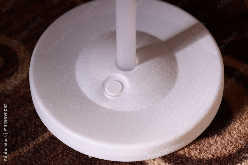 Poster a close-up shot of a white object on a carpet, great for highlighting small details.