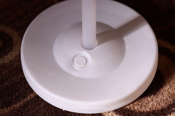 A close-up shot of a white object on a carpet, great for highlighting small details.