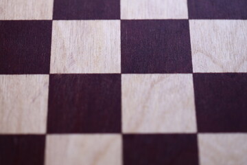 Fototapeta premium A detailed shot of a chessboard, ideal for highlighting game pieces or strategy planning.
