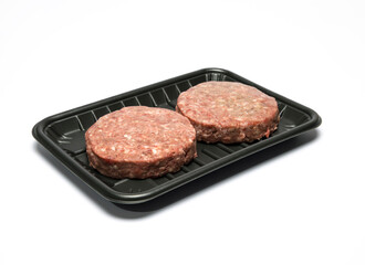 Raw hamburger slices on a plastic plate