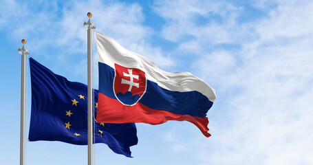 Slovakia and the European Union flags waving in the wind on a clear day