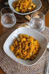 homemade recipe of mellow rice with shrimp and clams on a kitchen table