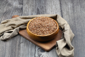 Flax seeds. Flaxseed powder in a wooden spoon. Standing on a Wooden background.
