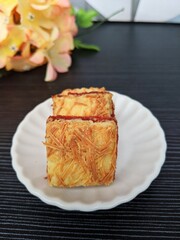 Strawberry cheese bar on a white saucer. Popular cookies for celebration of Eid Mubarak (Hari Raya). Malaysian famous dessert for Hari Raya