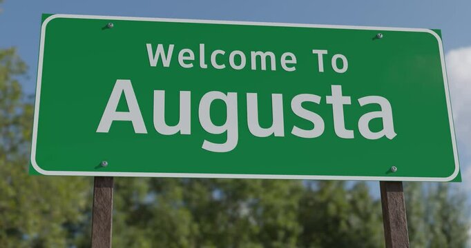 Driving By A Welcome To Augusta, Maine Green Road Sign Against a Blue Sky and Clouds - United States Capital Series.