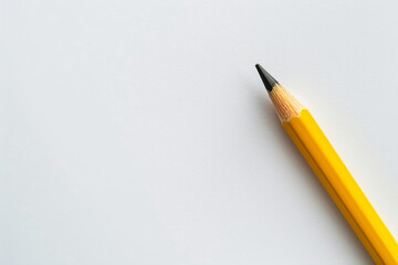 A yellow pencil on a white background, ready to write or draw, concept: writing, drawing, education, creativity