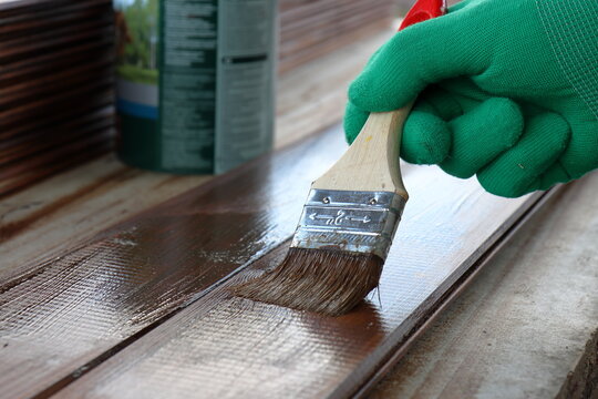 Applying a protective impregnation to the board with a brush. Antiseptic for wood