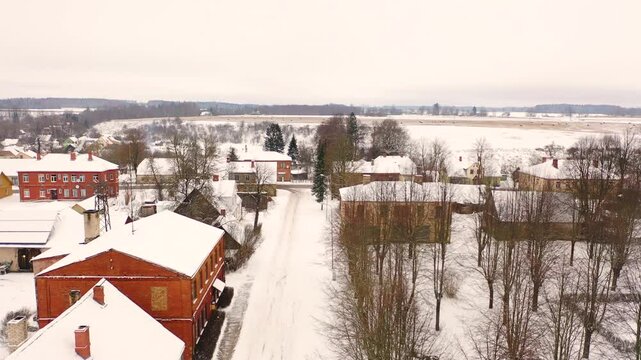 Akniste, Jekabpils, Latvia, Aerial 4K video from flying drone to &ldquo;Aknīste&rdquo; city in winter.Beautiful winter view with snowy snow on small town fields and forests.Small town in Latvia in winter. (series