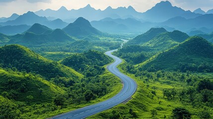 Scenic winding road journey through lush green hills and mountain range