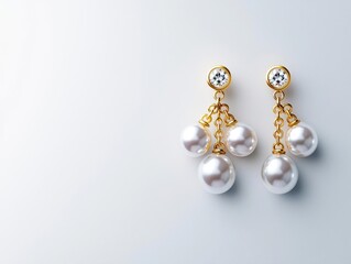 Elegant chandelier earrings with dangling pearl strands, isolated on a polished white background