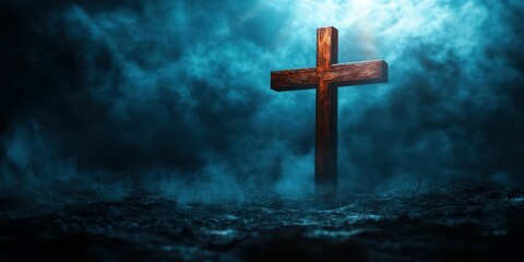 Fototapeta premium Dramatic wooden cross emerges from fog in a dark, misty landscape at twilight