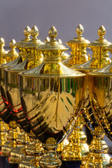 Several gold cups for awarding winners in sports competitions