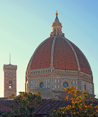 Obraz premium Unusual view of the bell tower of Giotto di Bondone and the Dome of Florence Cathedral in Italy and the big golden sphere