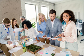 Group of professionals collaborating in a modern workspace during a team meeting