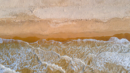 Aerial View of a Serene Beach in La Guajira, Colombia with Gentle Waves and Sandy Shoreline
