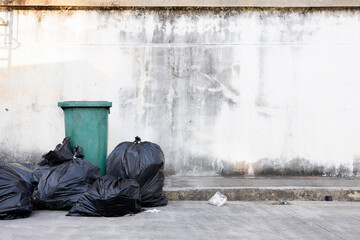 Overflowing Garbage with Recycling Concept on Dirty Urban Wall