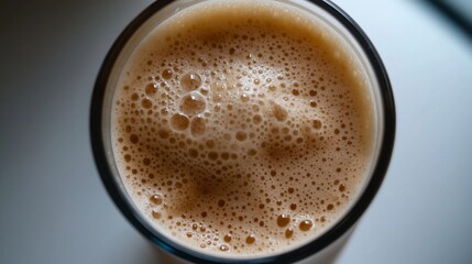 Invigorating frothy beverage in a glass, capturing the texture and light