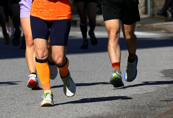 Fototapeta premium legs of the runner during the city race on the asphalt road