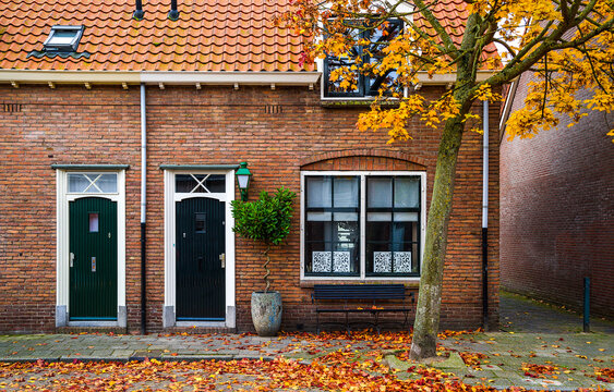 old brick wall with windows in autumn