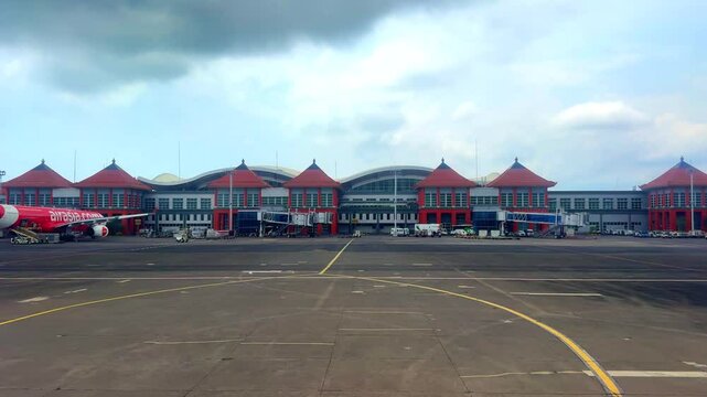 Bali airport viewed from airplane window showing buildings planes tarmac Bali Indonesia