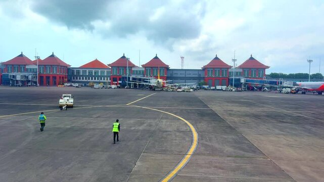 Bali airport viewed from airplane window showing buildings planes tarmac Bali Indonesia