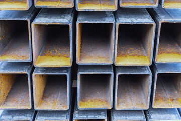  Stacked steel beams with rust, showcasing industrial texture and construction material, close-up perspective