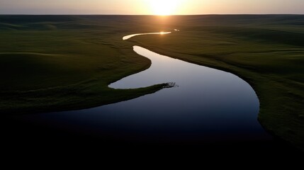 Fototapeta premium Serene river meandering through verdant landscape at sunrise
