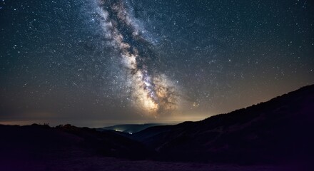 Fototapeta premium Stunning night sky with Milky Way galaxy visible over mountainous terrain