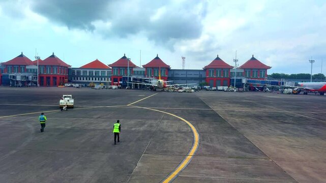 Bali airport viewed from airplane window showing buildings planes tarmac Bali Indonesia