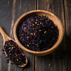 Black Rice in a Wooden Bowl with Raw Grains Scattered
