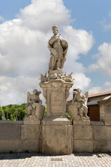 Stone statue of Emperor Charles IV stands on parapet of Baroque Gallery in historical part of Kutna Hora city in Czech Republic